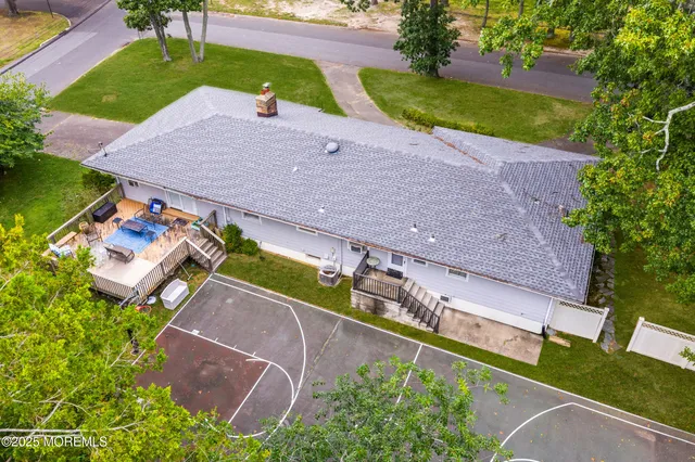 an aerial view of a house with a yard