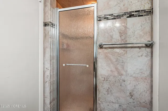 a bathroom with a glass shower door