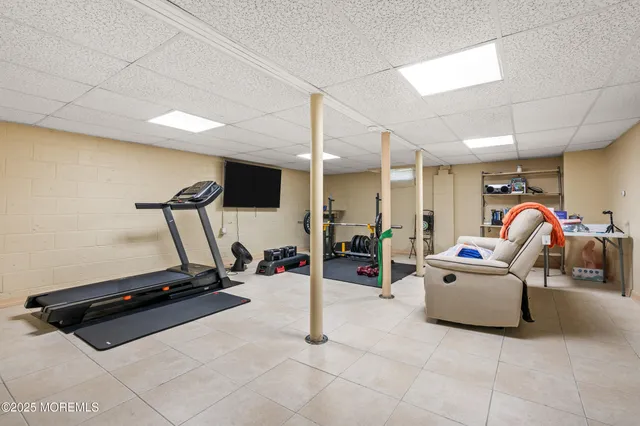 a room with gym equipment and a table