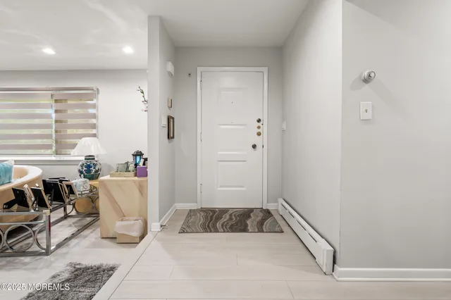 a bathroom with a tub sink and glass door