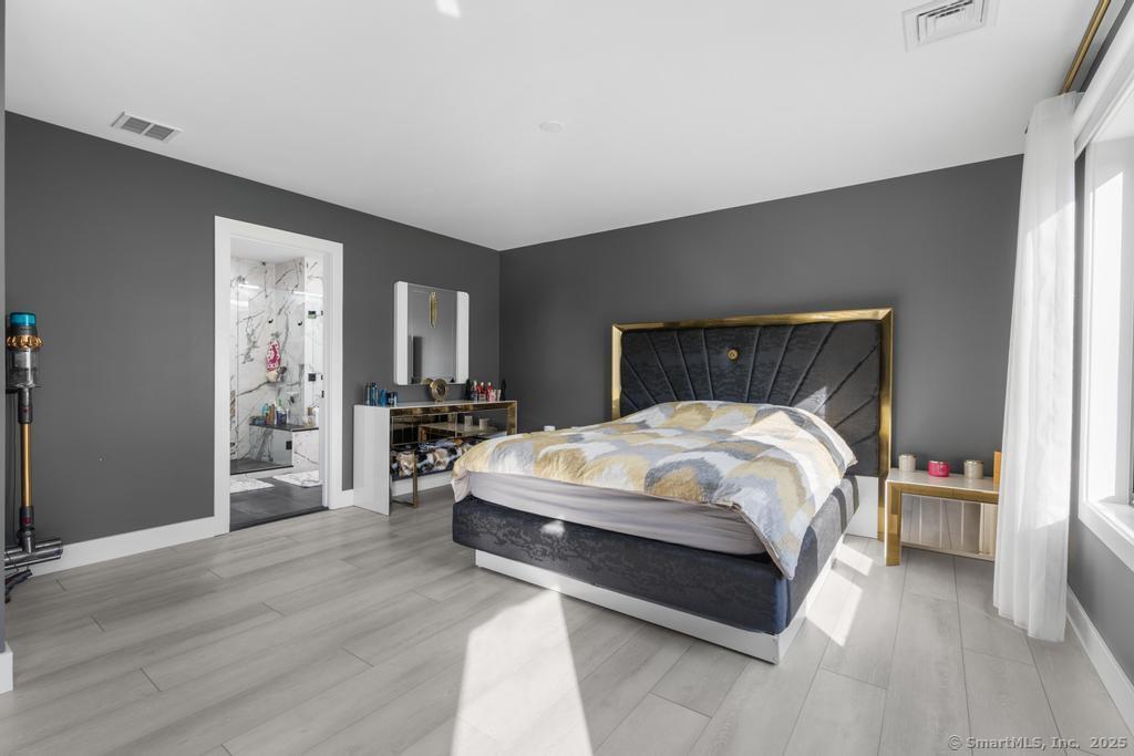 6 Vinnie Drive Wethersfield, CT 06109 - Photo 20 of 36 a bed sitting in a spacious bedroom next to a cabinet and a flat screen tv