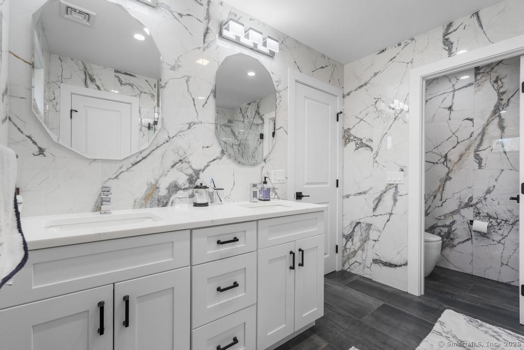 6 Vinnie Drive Wethersfield, CT 06109 - Photo 23 of 36 a bathroom with a double vanity sink mirror and shower