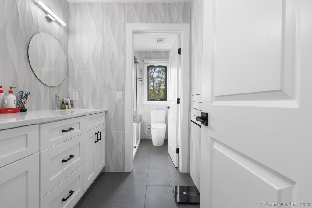 6 Vinnie Drive Wethersfield, CT 06109 - Photo 24 of 36 a bathroom with a double vanity sink mirror and toilet