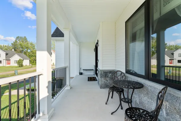 a balcony with furniture and wooden floor