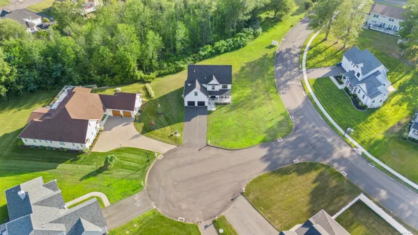 an aerial view of a house with a swimming pool and garden