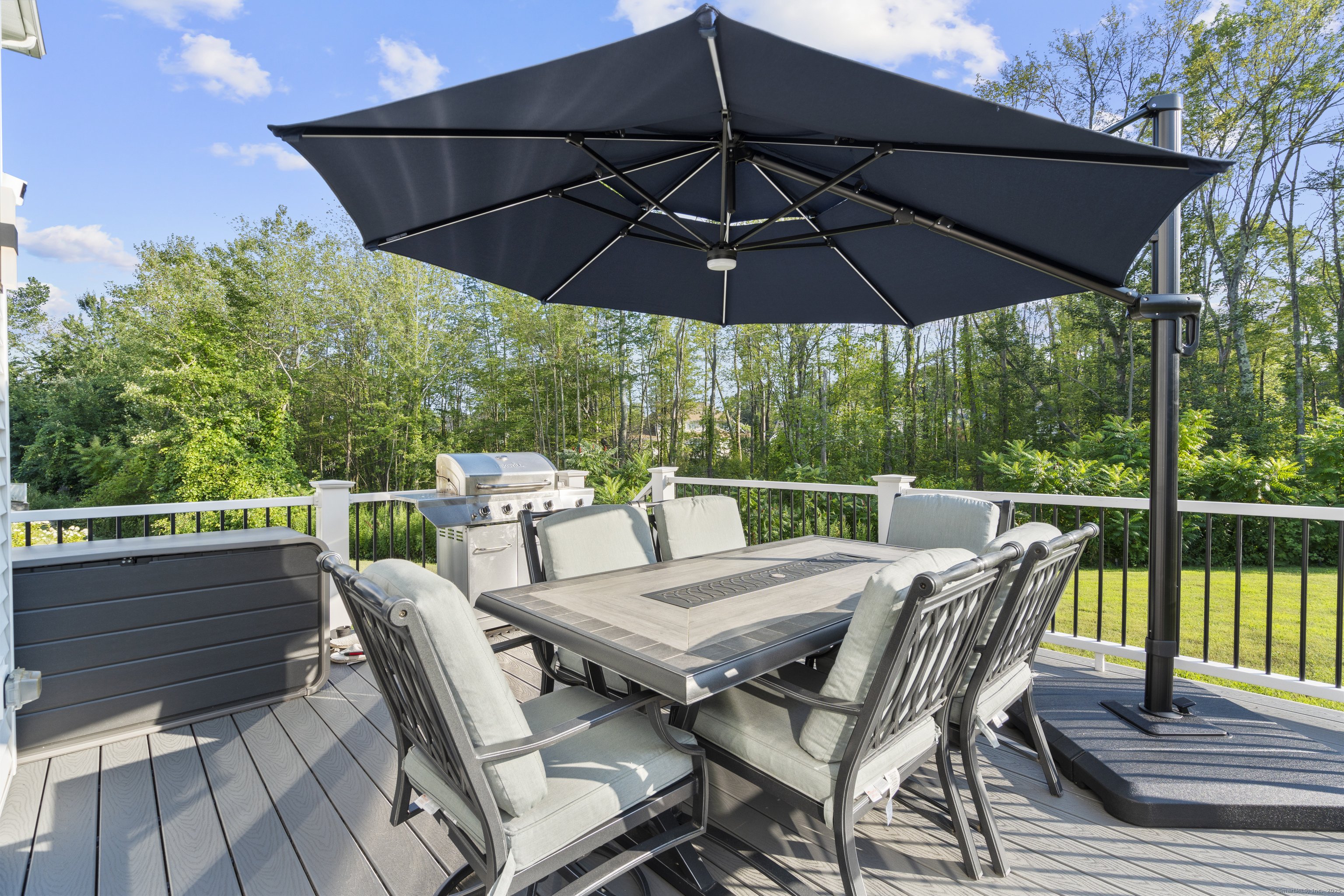 6 Vinnie Drive Wethersfield, CT 06109 - Photo 8 of 36 a view of a roof deck with table and chairs under an umbrella
