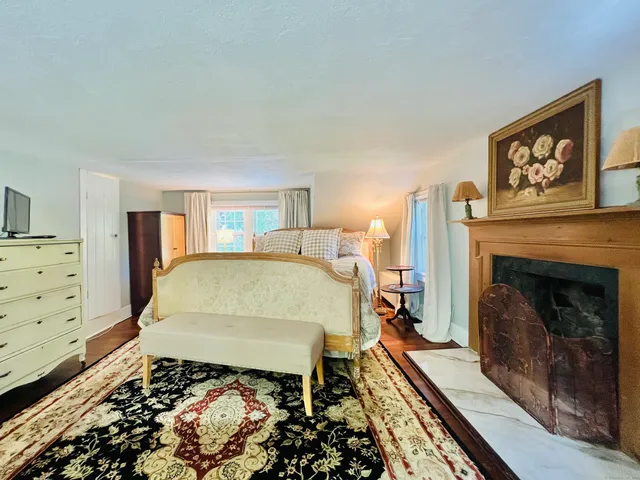 a bed sitting in a bedroom next to a fireplace