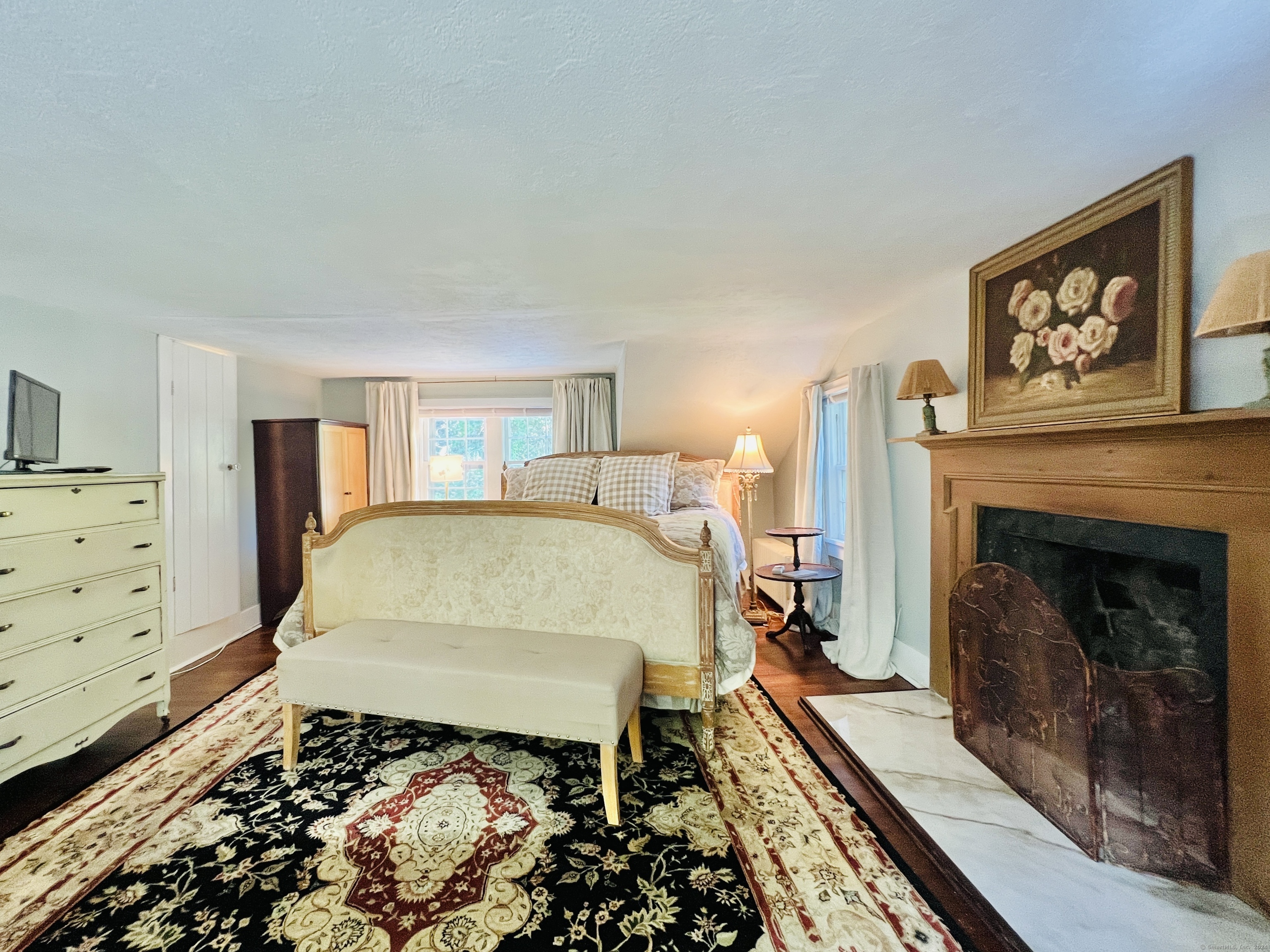 301 Haviland Road Stamford, CT 06903 - Photo 19 of 34 a bed sitting in a bedroom next to a fireplace