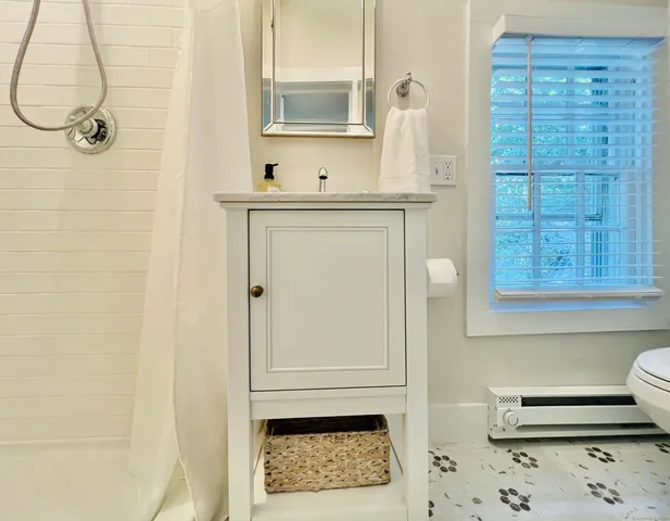 a bathroom with a sink a mirror and a shower