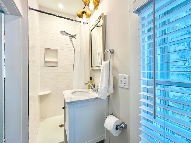 a bathroom with a shower and a sink
