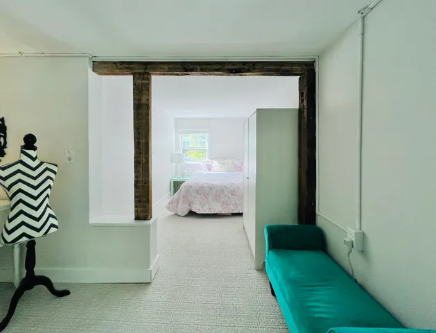 a bedroom with a bed and a mirror