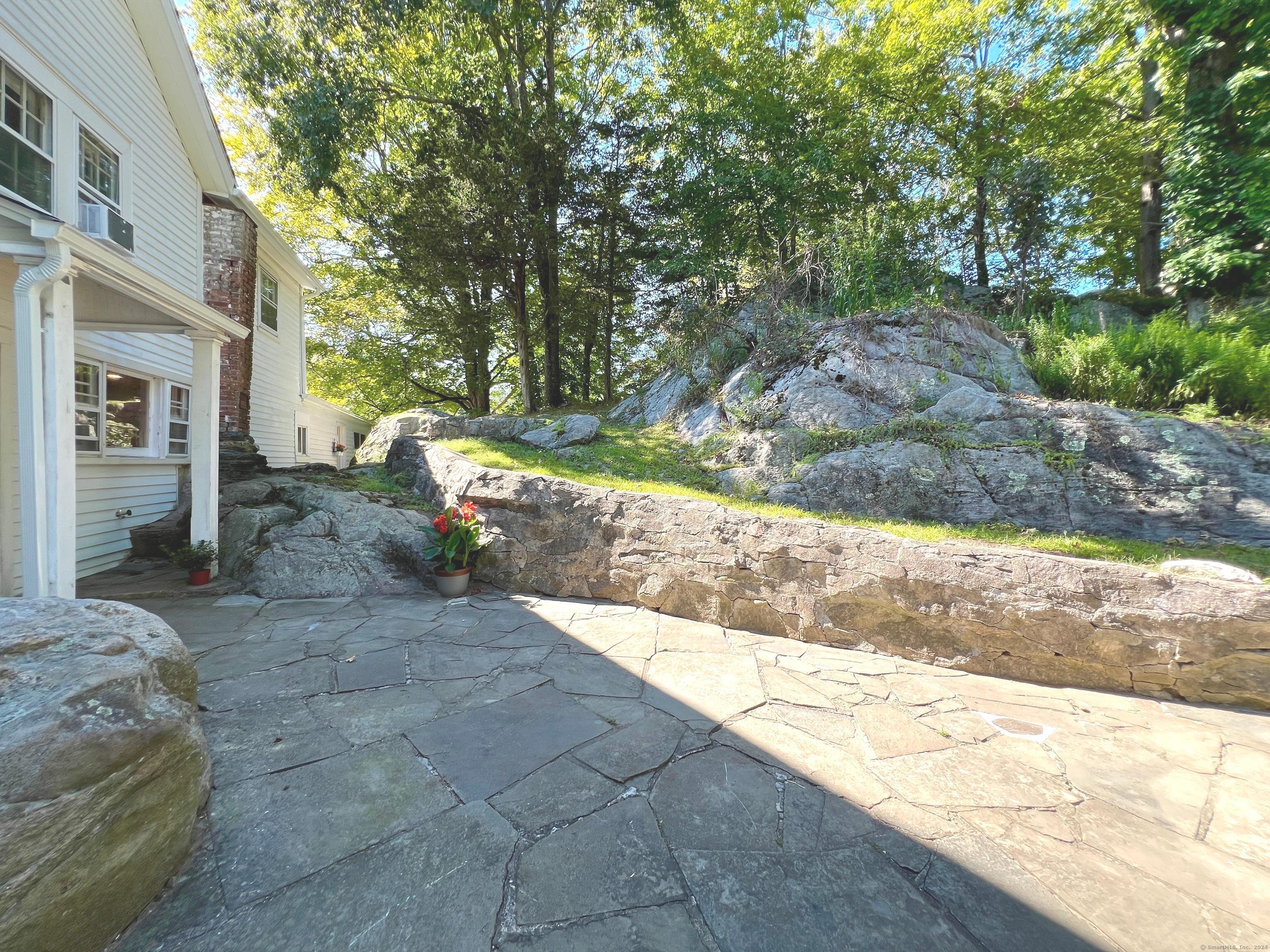 301 Haviland Road Stamford, CT 06903 - Photo 3 of 34 a view of a backyard with large trees