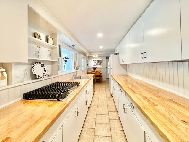 a large kitchen with stainless steel appliances granite countertop a stove and cabinets