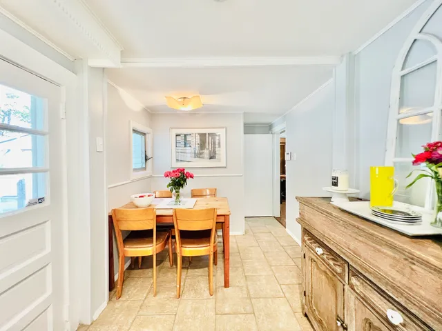 a view of a dining room with furniture and a potted plant