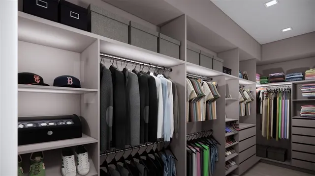 a view of walk in closet with clothes and shoes