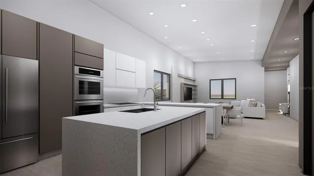 a kitchen that has a lot of cabinets a sink and appliances