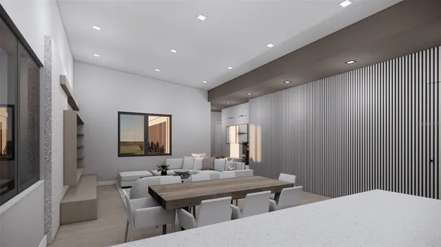 a room with a table chairs and a wooden floor