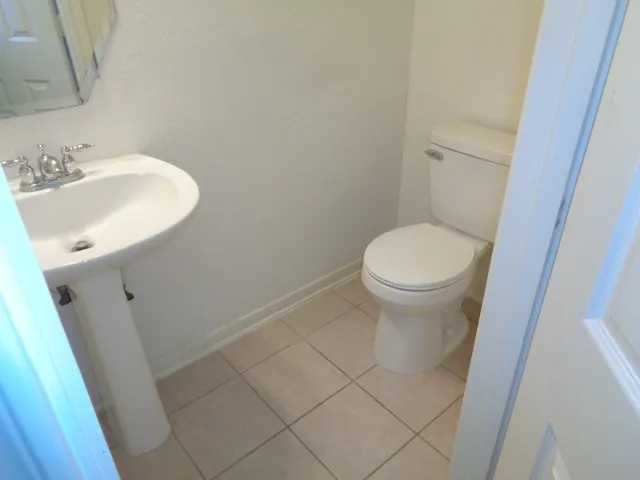 a white toilet sitting next to a white sink