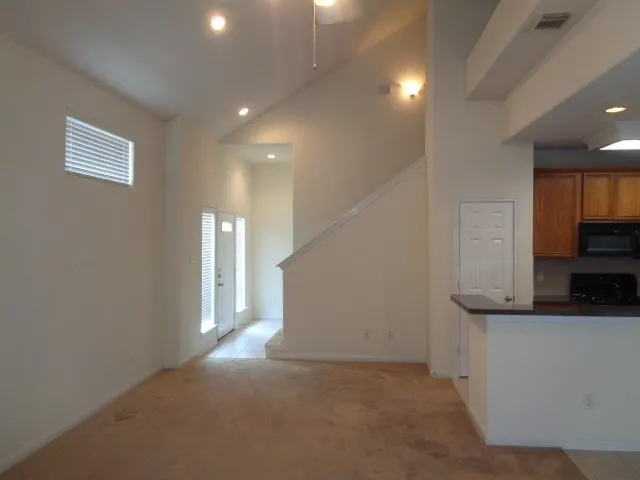a view of a kitchen with a sink and a refrigerator