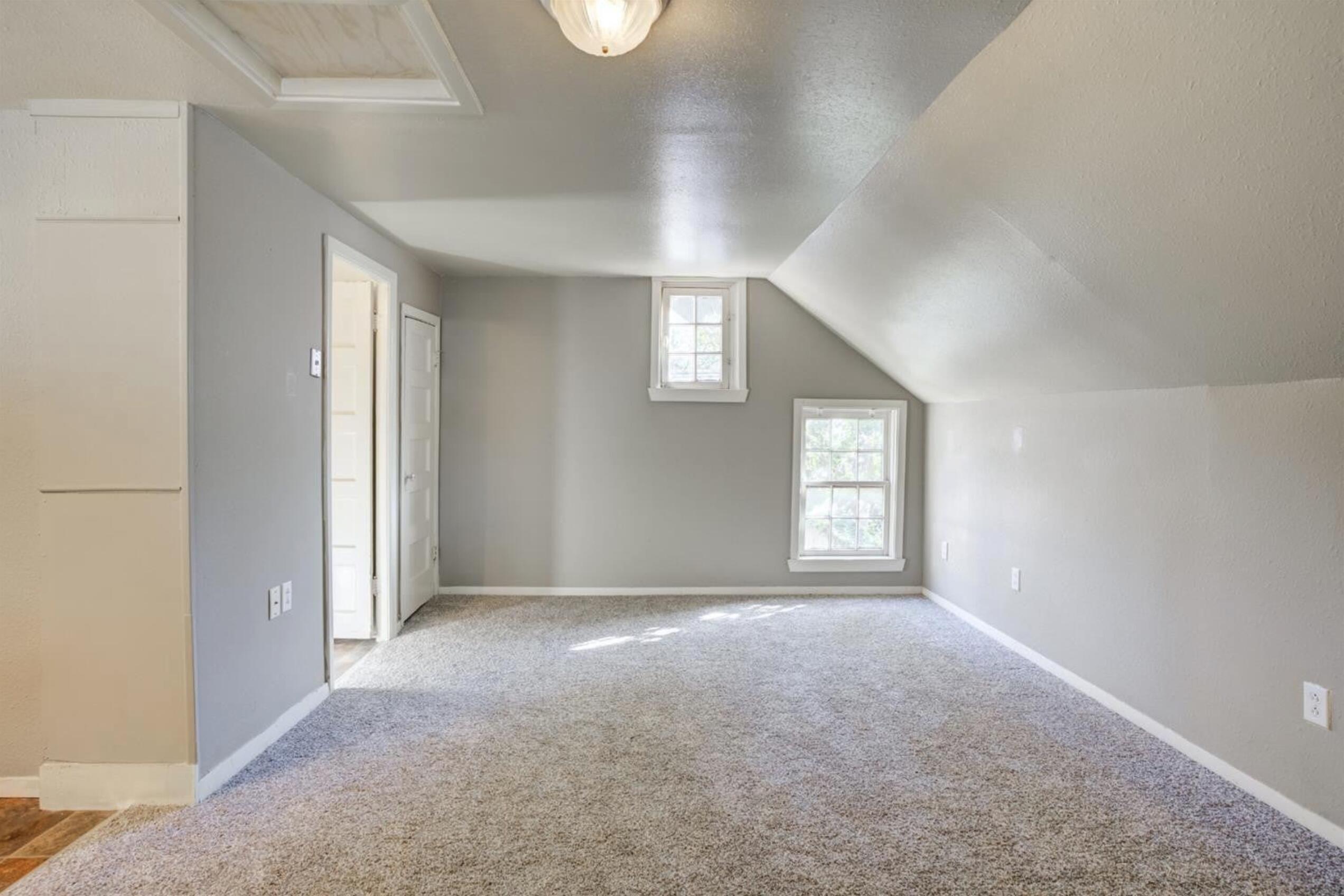 2702 20th Street Lubbock, TX 79410 - Photo 34 of 34 a view of a big room with windows and chandelier fan