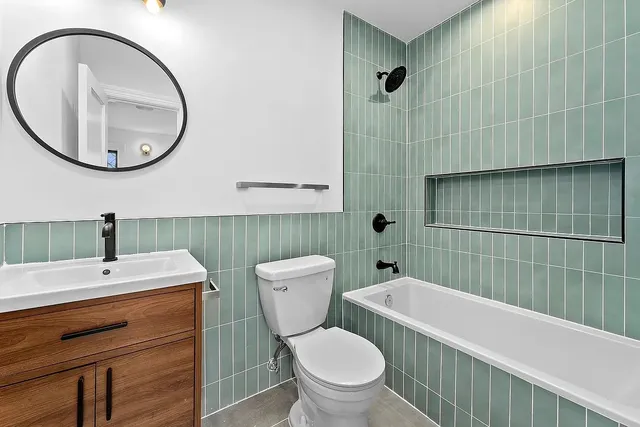 a bathroom with a toilet a sink and a mirror