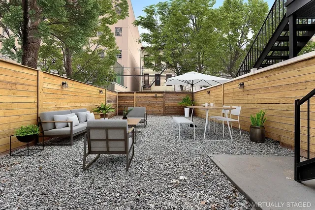 a view of a patio with a table and chairs under an umbrella