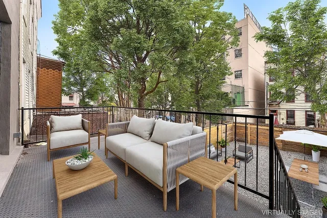 a roof deck with couches and wooden floor