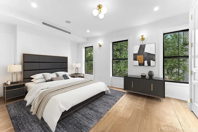 a bedroom with a large bed and a window