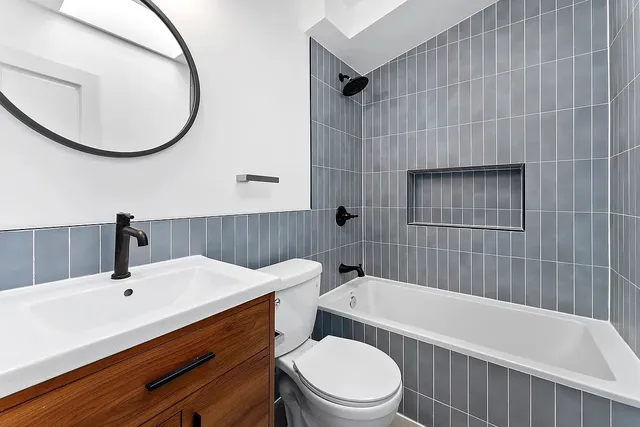 a bathroom with a sink a toilet and bathtub