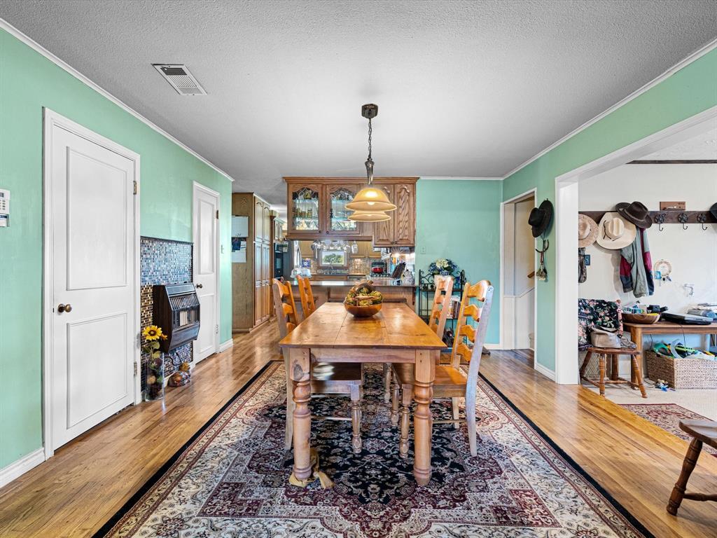 117 County Road 2646 Decatur, TX 76234 - Photo 25 of 39 a view of a dining room with furniture window and wooden floor