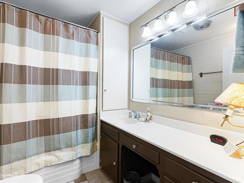 117 County Road 2646 Decatur, TX 76234 - Photo 7 of 39 a bathroom with a sink and a mirror