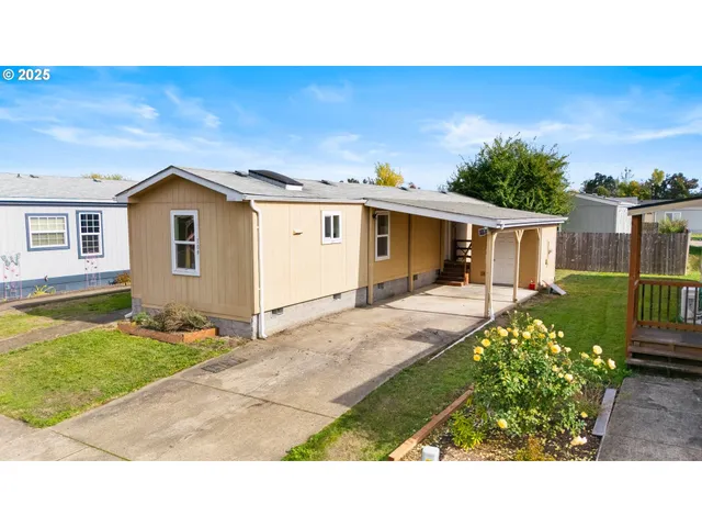 a view of house with backyard and garden