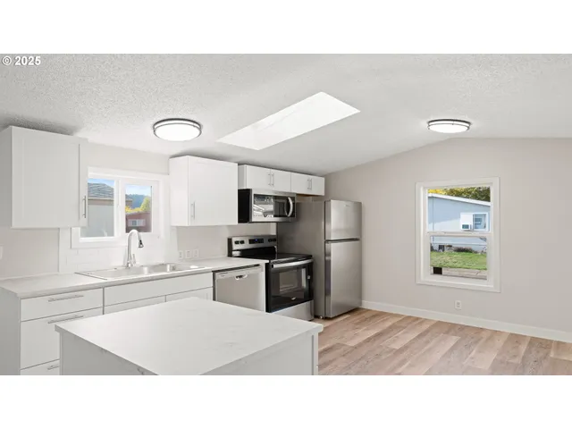 a kitchen with a stove a sink and a refrigerator