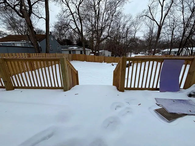 a view of street with wooden fence