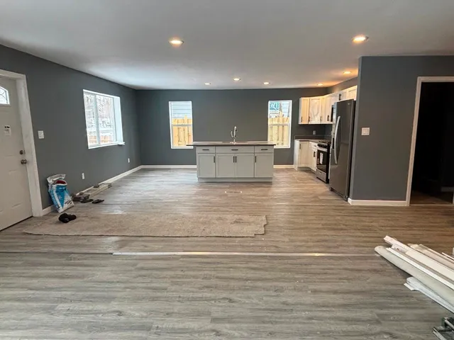 a view of kitchen with windows and refrigerator