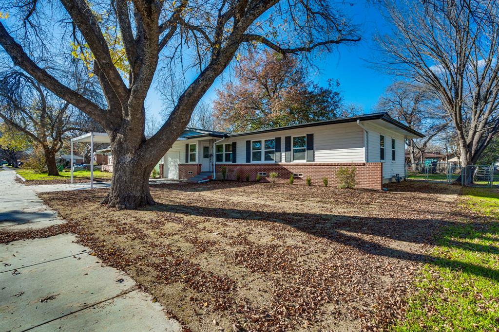205 Cumberland Road Waxahachie, TX 75165 - Photo 1 of 1 a front view of a house with a yard covered with snow and trees