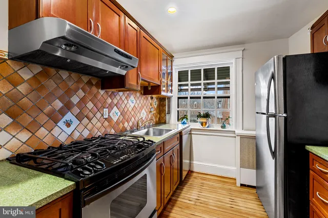 a kitchen with a stove and a refrigerator