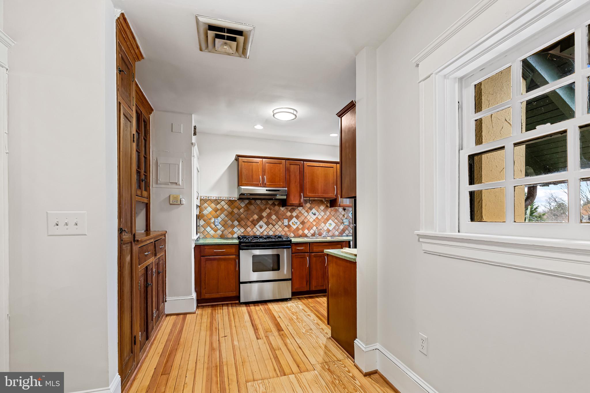 4300 Roland Avenue, Unit 302 Baltimore, MD 21210 - Photo 12 of 43 a kitchen with stainless steel appliances granite countertop a stove and a refrigerator