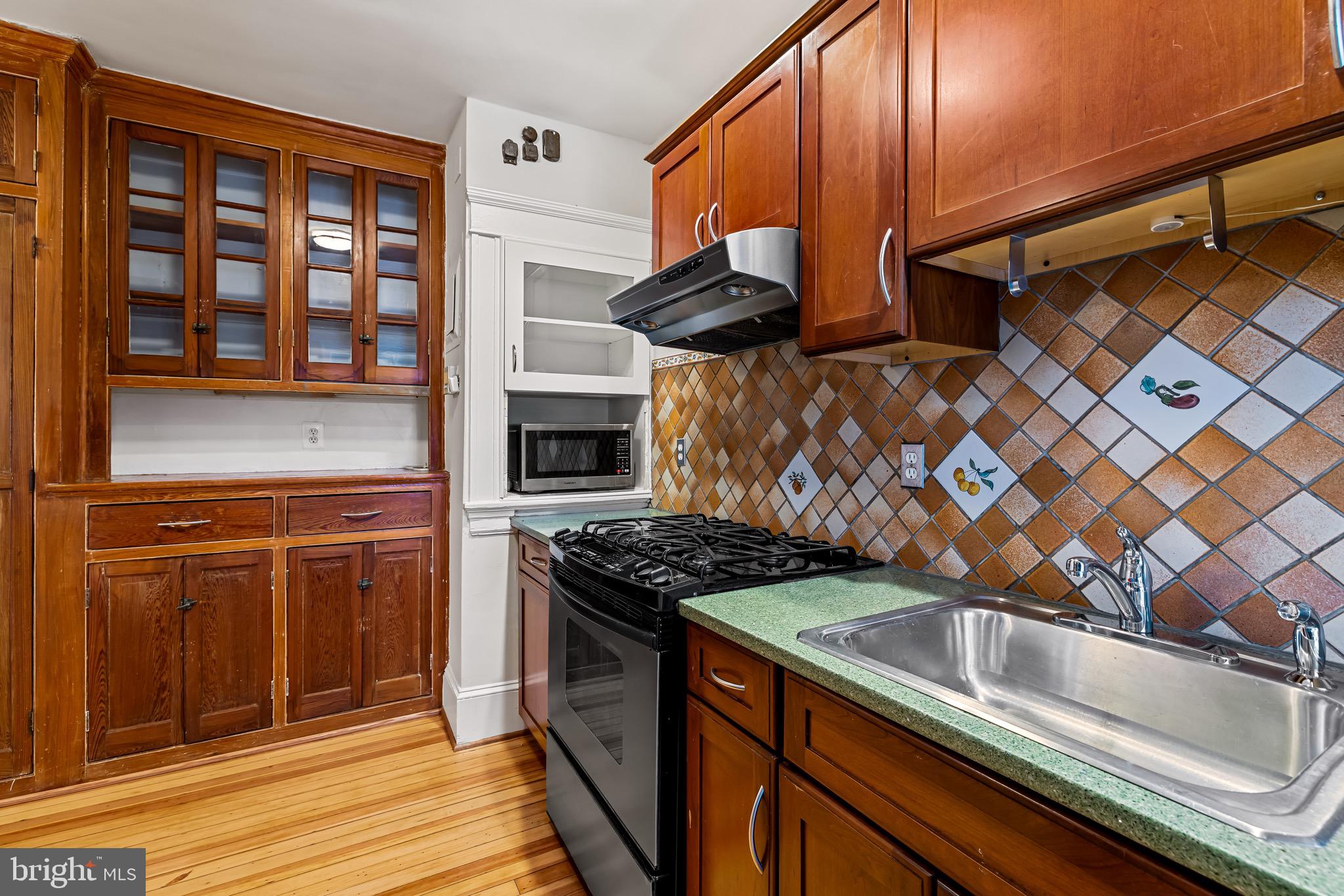 4300 Roland Avenue, Unit 302 Baltimore, MD 21210 - Photo 14 of 43 a kitchen with stainless steel appliances granite countertop a stove and a sink