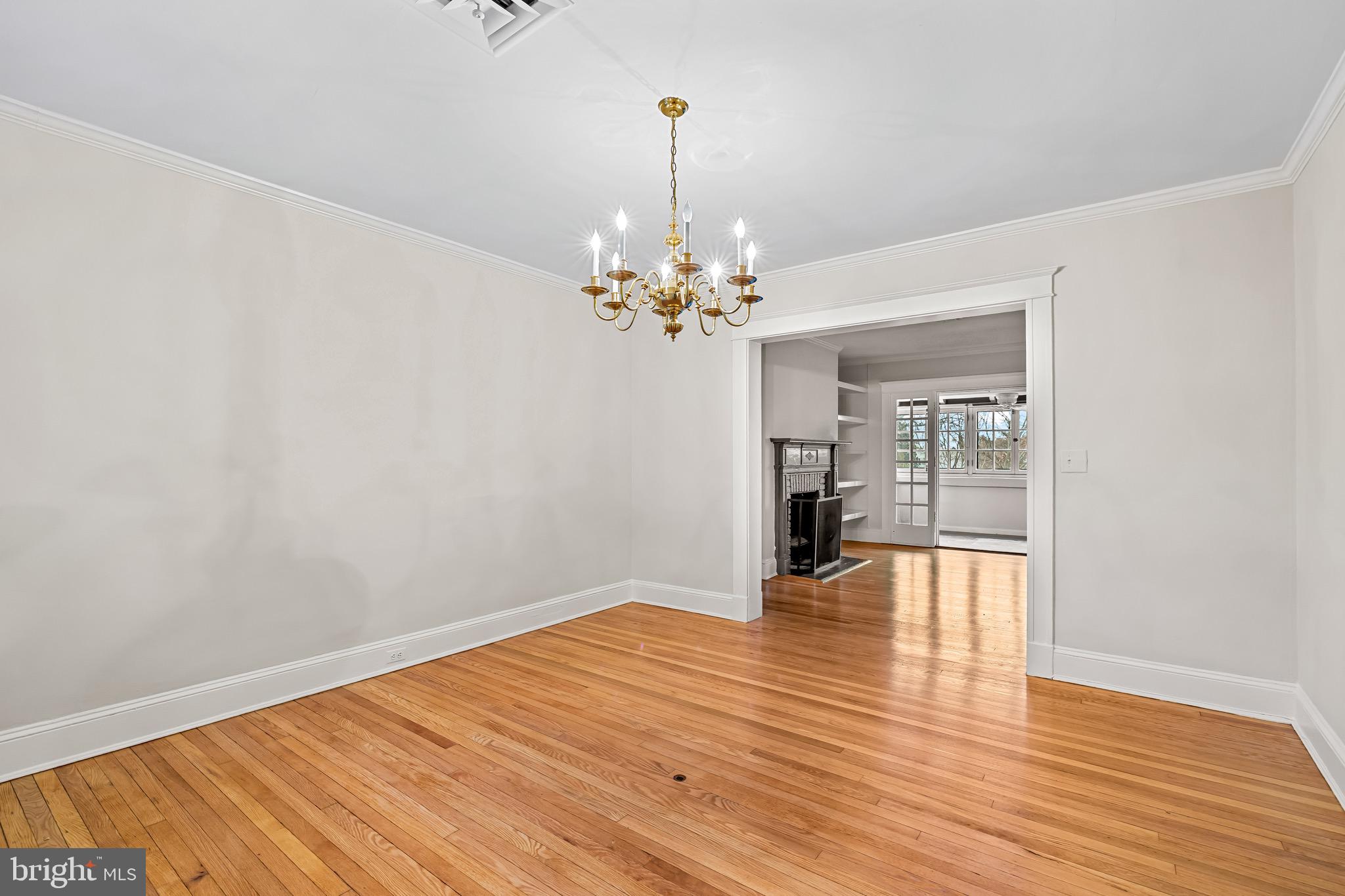 4300 Roland Avenue, Unit 302 Baltimore, MD 21210 - Photo 15 of 43 wooden floor in an empty room with a window