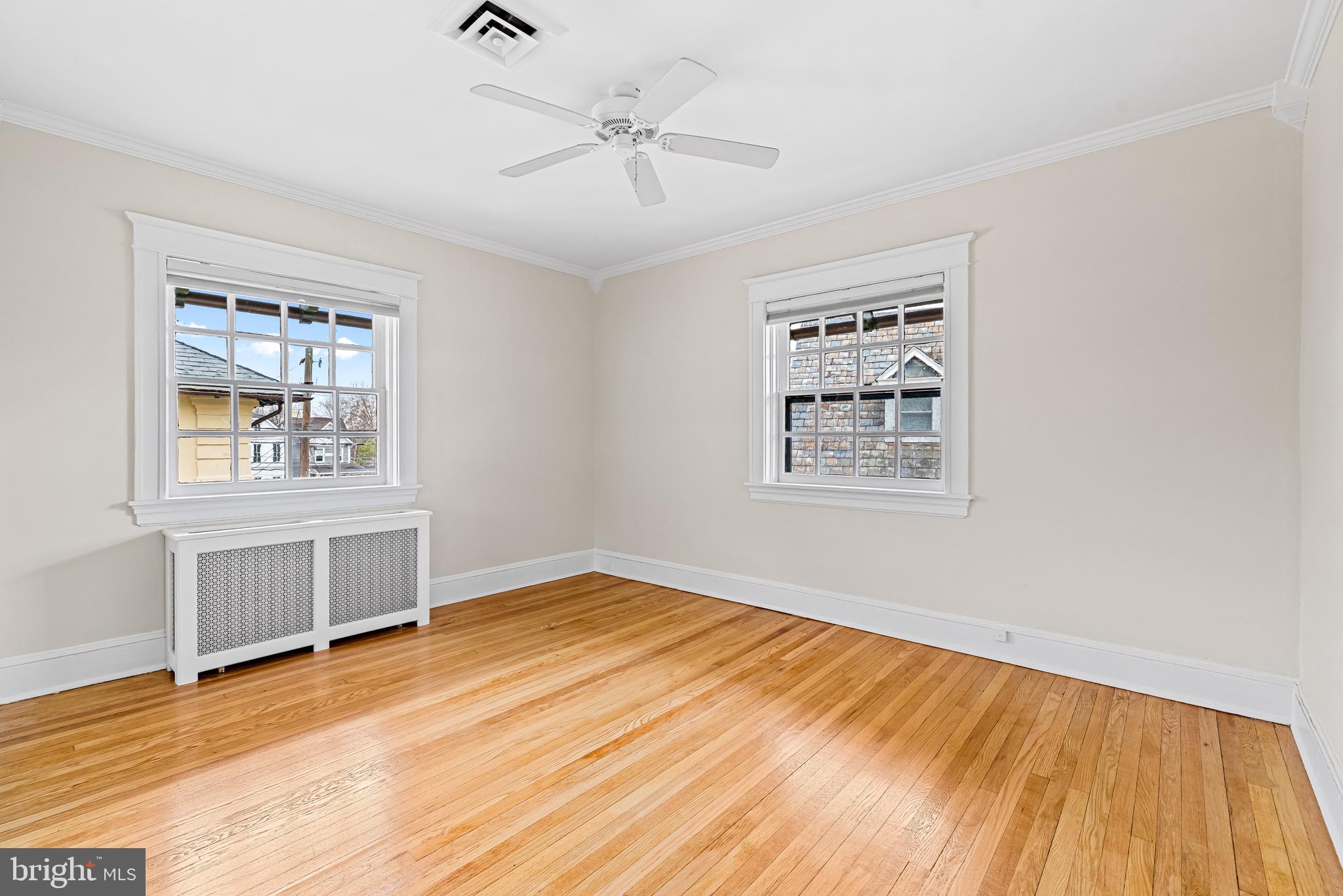 4300 Roland Avenue, Unit 302 Baltimore, MD 21210 - Photo 18 of 43 a view of an empty room with window and wooden floor