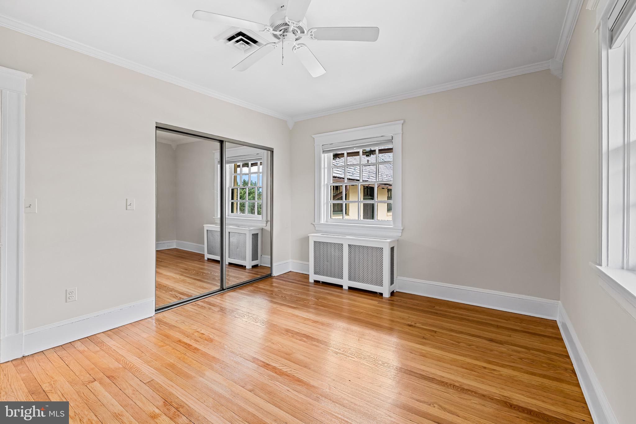 4300 Roland Avenue, Unit 302 Baltimore, MD 21210 - Photo 19 of 43 a view of an empty room with wooden floor and a window