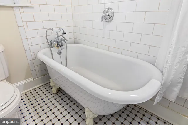 a bath tub sitting next to a white toilet