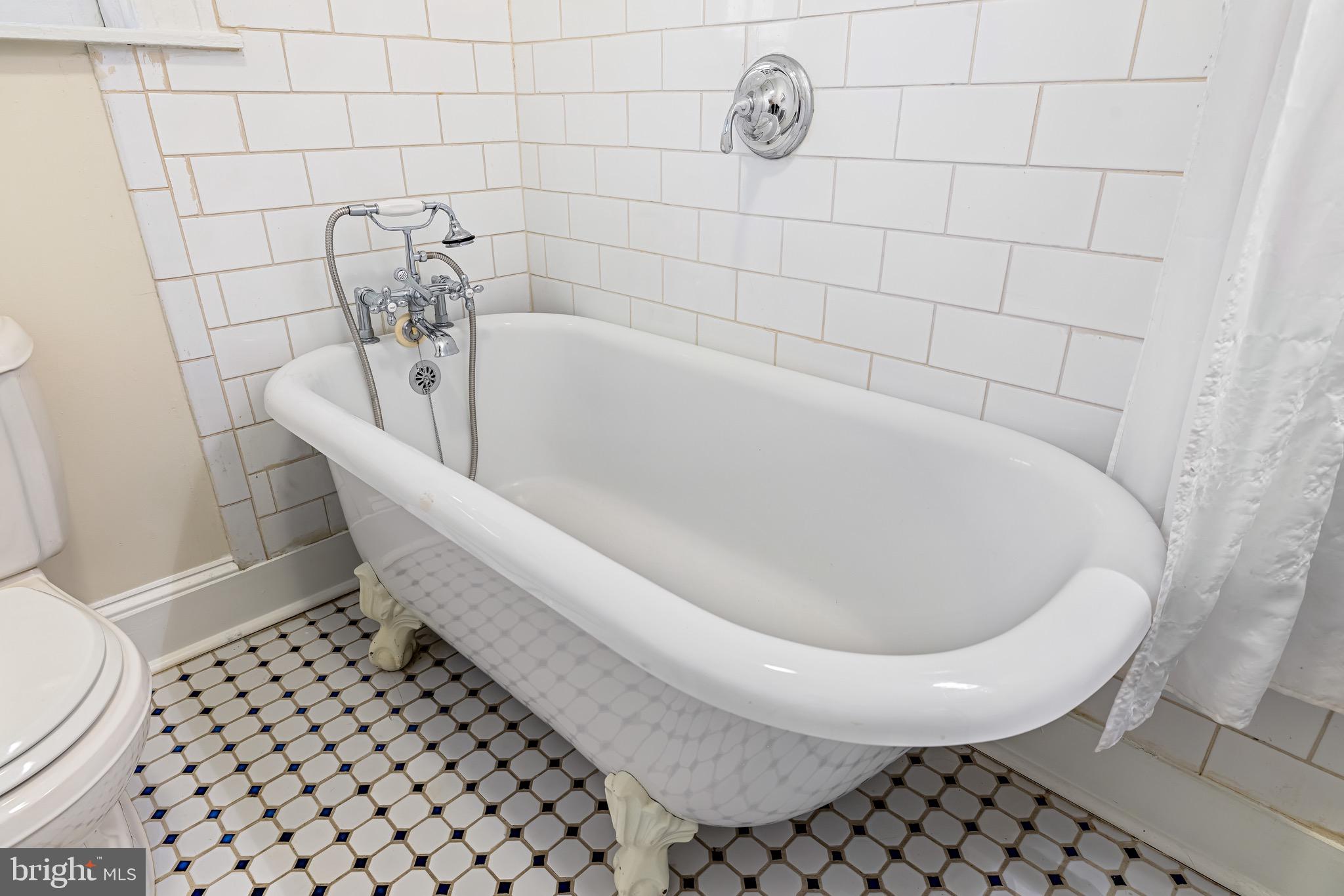4300 Roland Avenue, Unit 302 Baltimore, MD 21210 - Photo 23 of 43 a bath tub sitting next to a white toilet