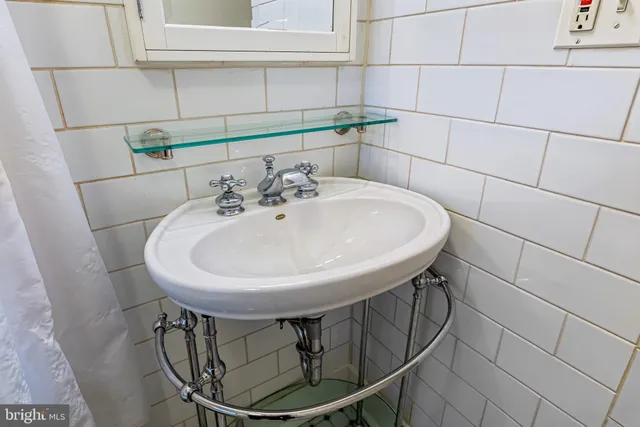 a bathroom with a sink and mirror