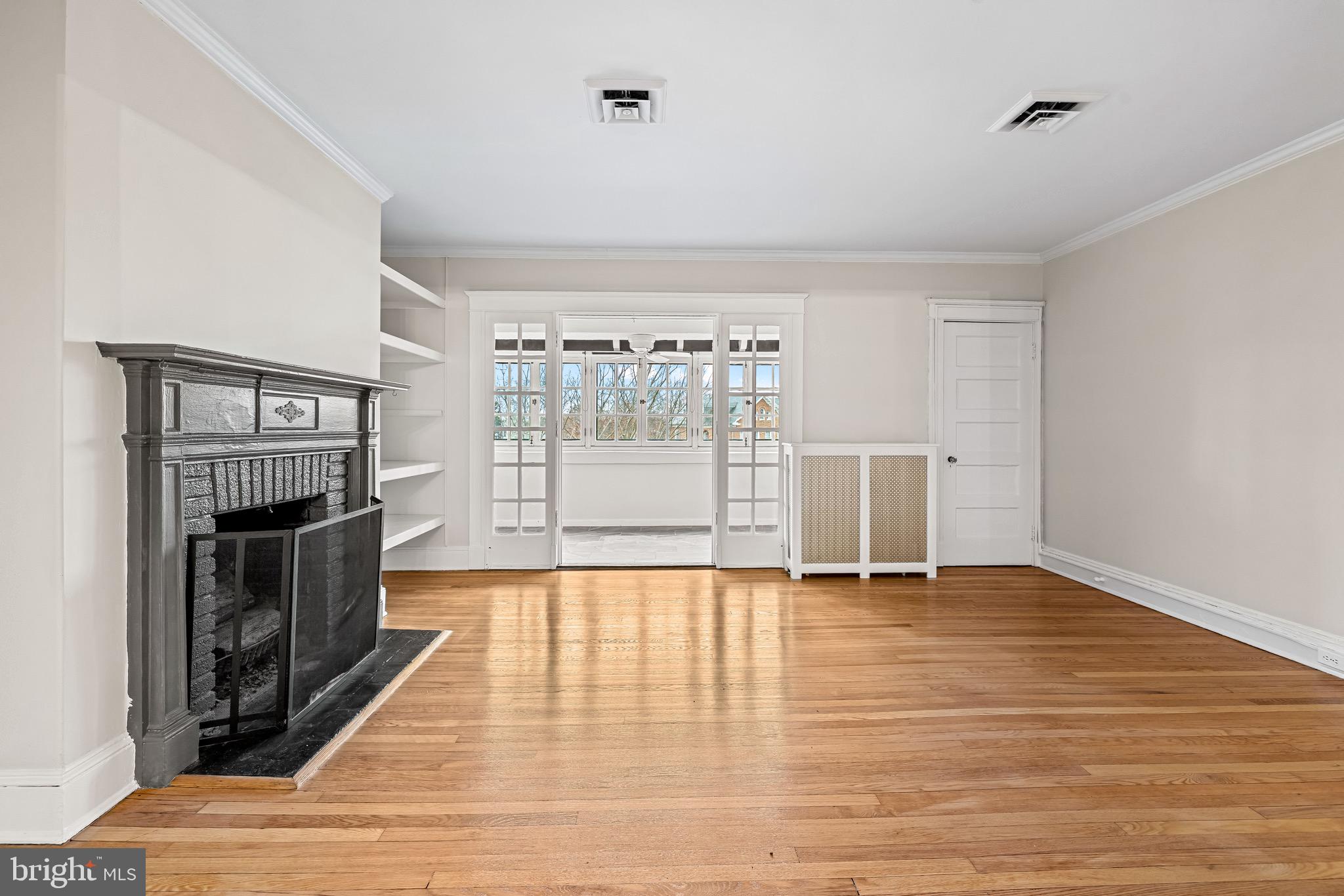 4300 Roland Avenue, Unit 302 Baltimore, MD 21210 - Photo 3 of 43 a view of empty room with wooden floor and fireplace