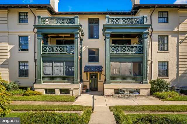 front view of a brick house with a small yard