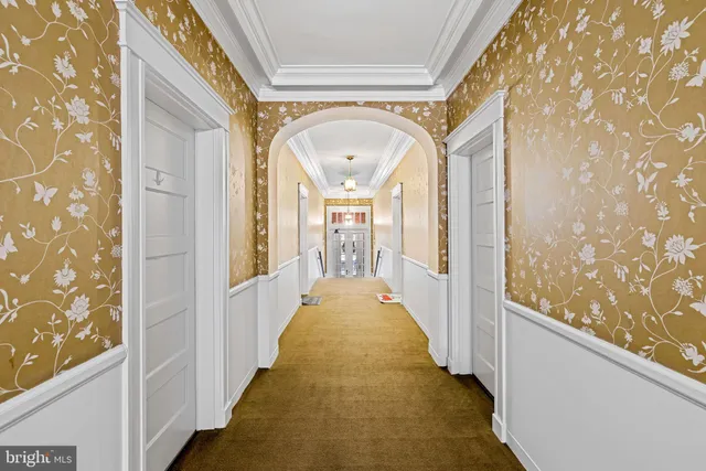a view of a hallway with wooden floor and glass door