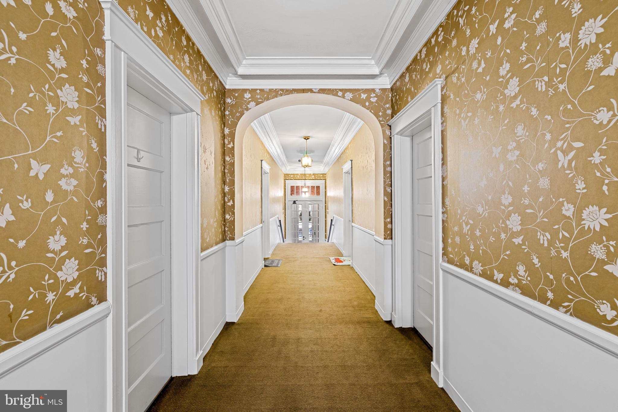 4300 Roland Avenue, Unit 302 Baltimore, MD 21210 - Photo 39 of 43 a view of a hallway with wooden floor and glass door