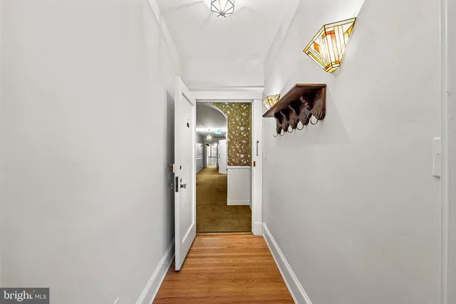 a view of a hallway with wooden floor